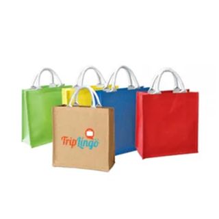 Green, yellow, blue, red and natural jute tote bags with off-white handles, the natural bag in front printed with a logo