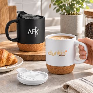Black and white ceramic mugs with cork bases and lids on a breakfast table, printed with sample logos