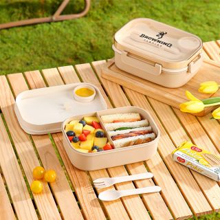 Bamboo fiber lunch box open on an outdoor table with food filling its compartments
