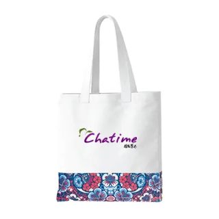White canvas tote bag with two long shoulder handles, a blue and red floral band printed across the lower front panel and a sample logo printed on the plain area above it