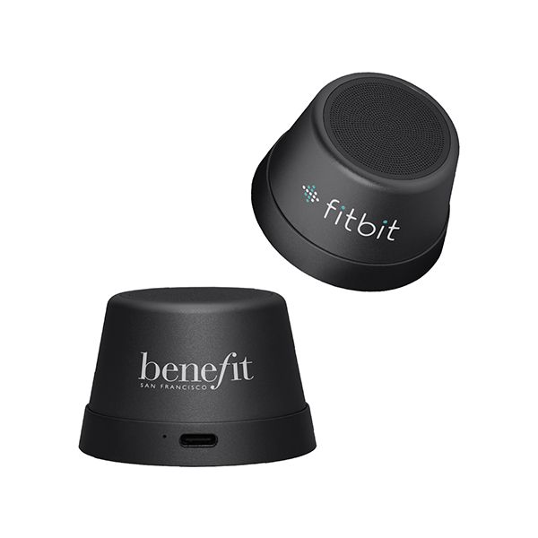 Two small round black Bluetooth speakers, one tilted on its side, each printed with a logo