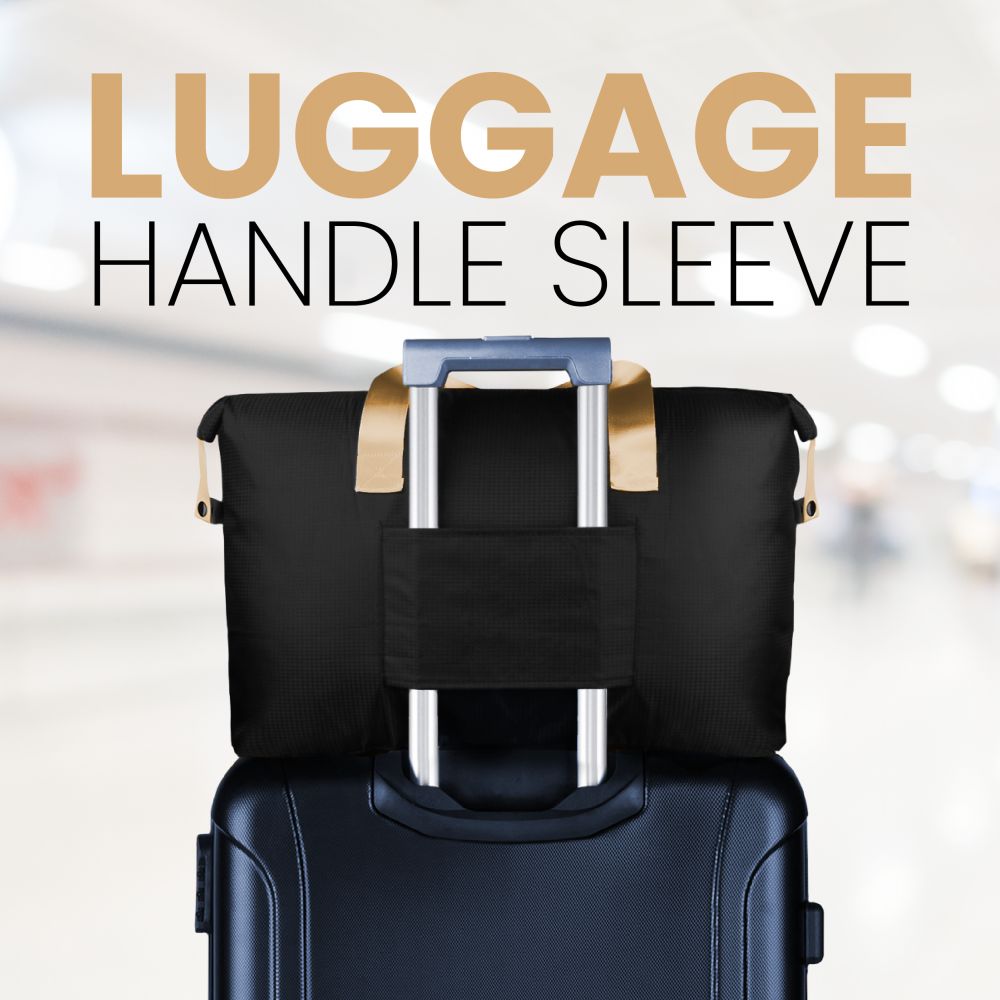 Black duffel bag slipped over the handle of a suitcase with its luggage sleeve
