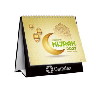 Kalendar Hijrah desk calendar standing closed on its hard stand with a black base band, cover showing gold crescent and lantern Islamic artwork