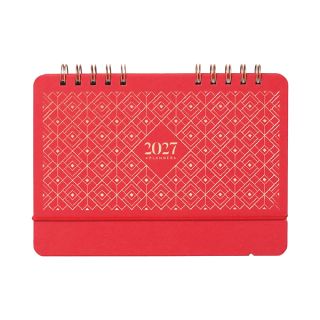 Coral red desk calendar with a diamond lattice cover, standing closed.