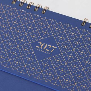 Close up of the navy cover showing the gold diamond lattice and the rose gold wire binding.