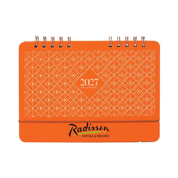 Orange wire-o desk calendar standing upright, its cover in a diamond lattice pattern with a logo printed on the base panel.