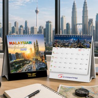 Two Malaysian Splendor desk calendars on a desk, one closed at the cover and one open at a monthly page