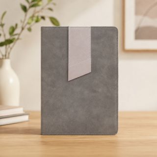 Grey thermo PU personal notebook standing on a wooden shelf